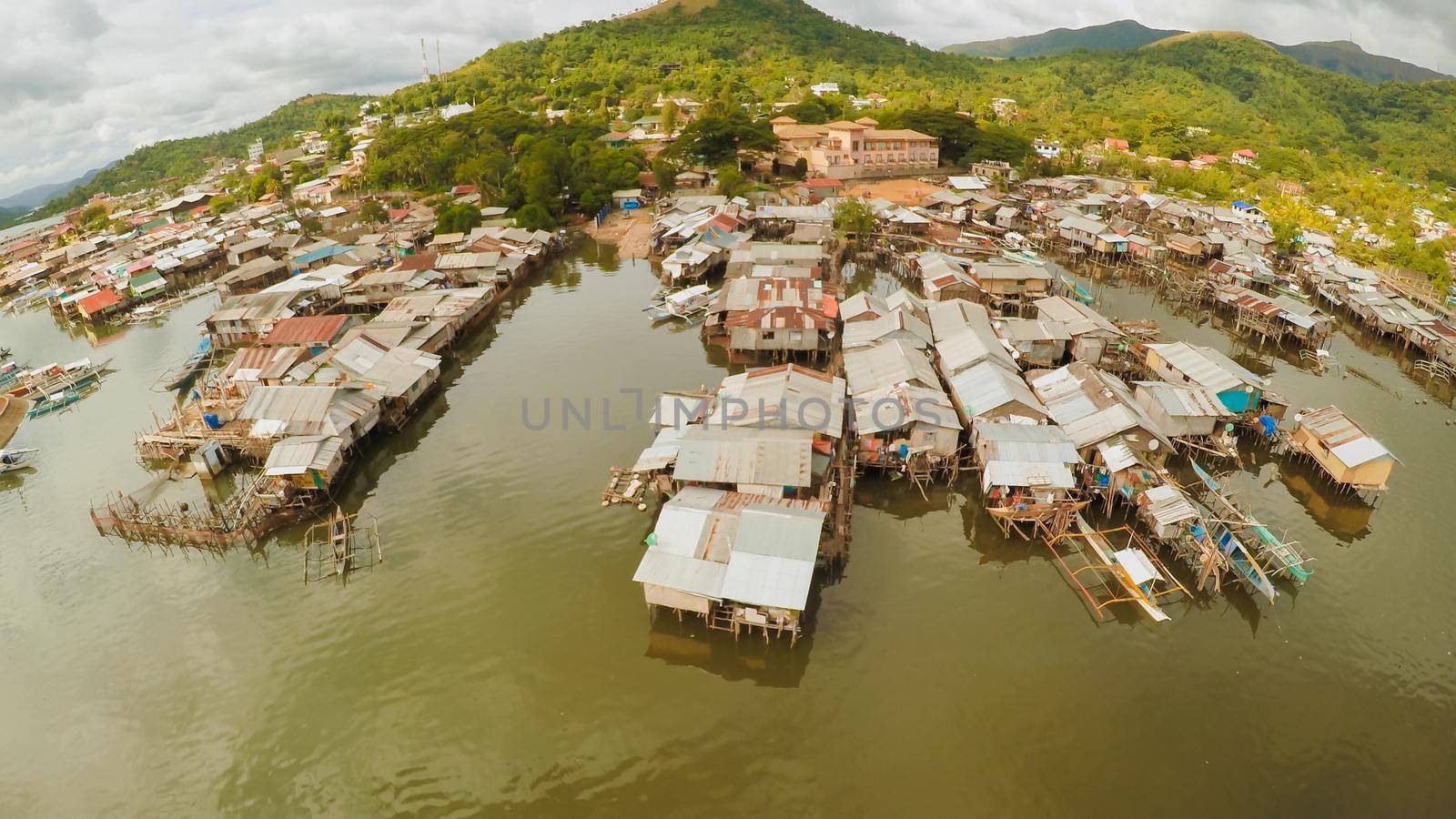 Philippine slums on the beach. Poor area of the city. Coron. Palawan. Philippines. by DovidPro