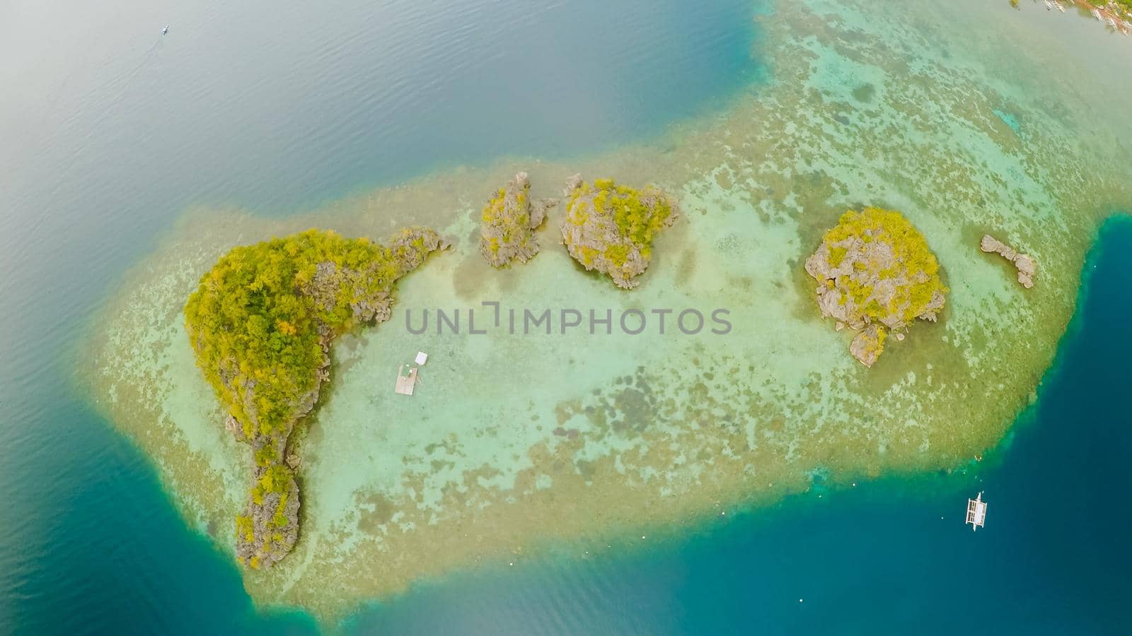 Aerial view of small islands Siete Pecados near in Coron Bay. Palawan. Overcast by DovidPro