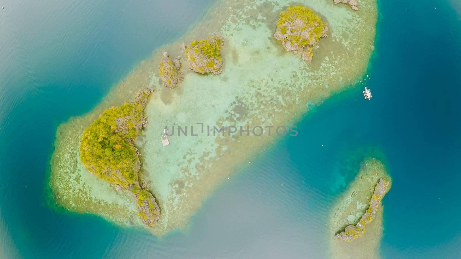 Aerial view of small islands Siete Pecados near in Coron Bay. Palawan. Overcast by DovidPro