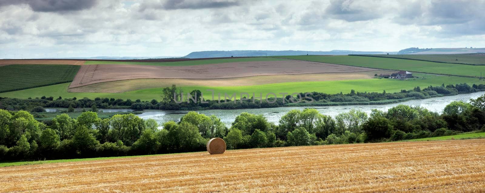 lake bairon in countryside of northern france under cloudy sky
