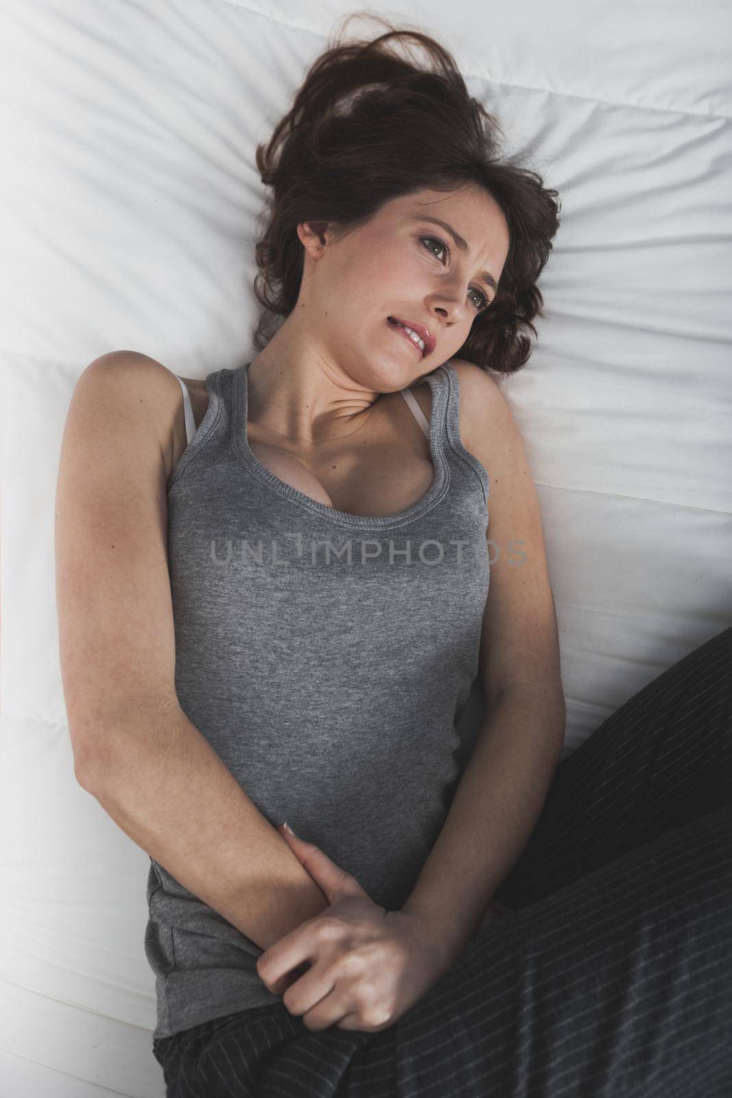 Portrait of a young woman in pain with Premenstrual Syndrome