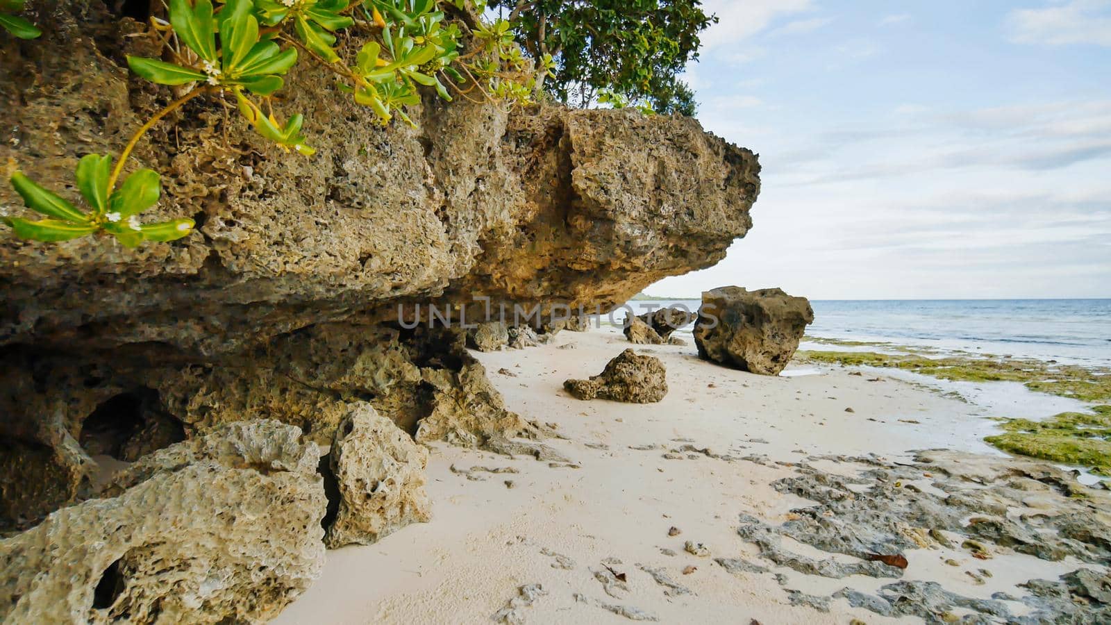 Beautiful wild tropical beach near Anda with granite rocks. Bohol Island. Philippines
