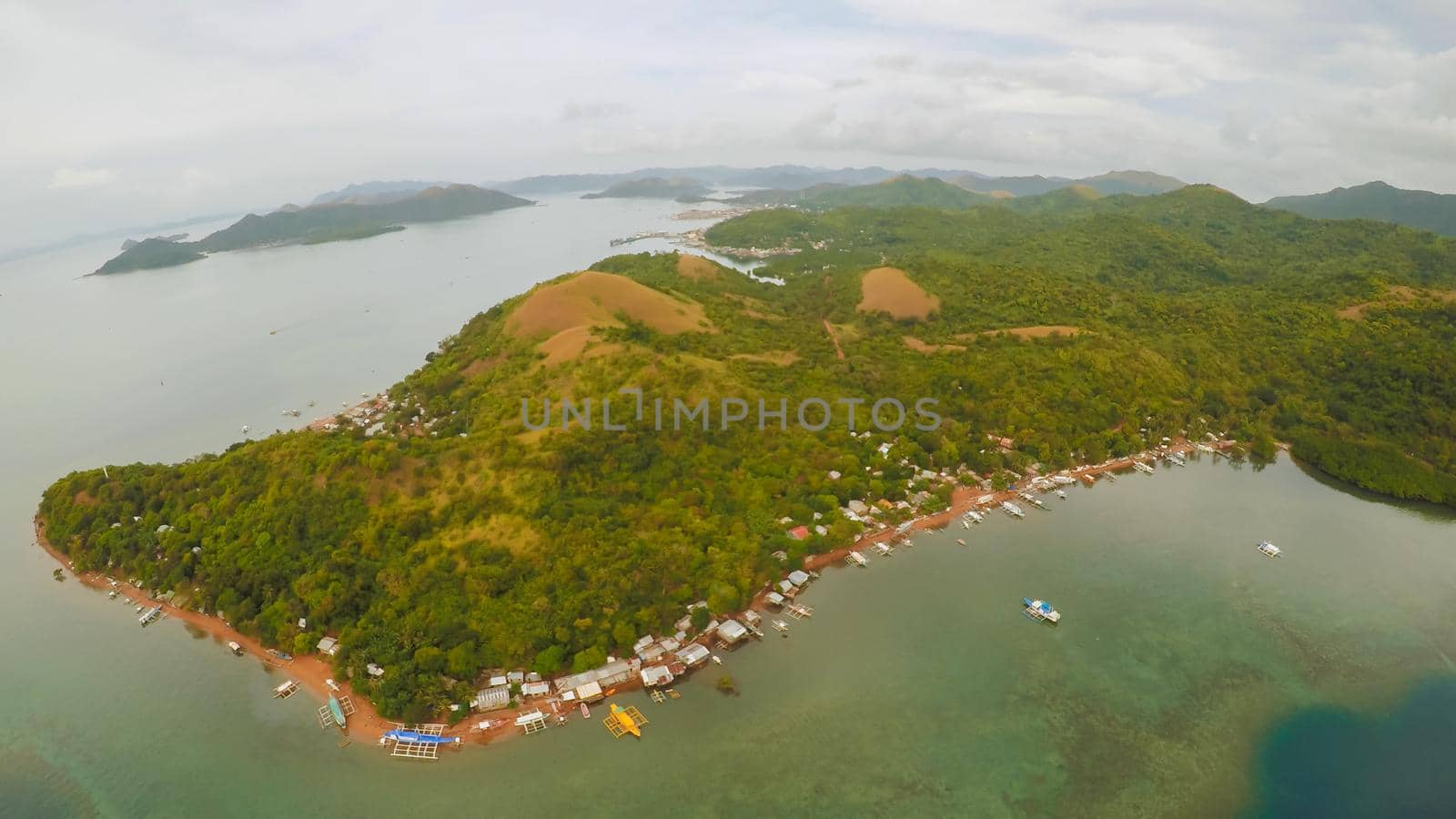 Aerial view of small islands Siete Pecados with boats in Coron Bay. Palawan