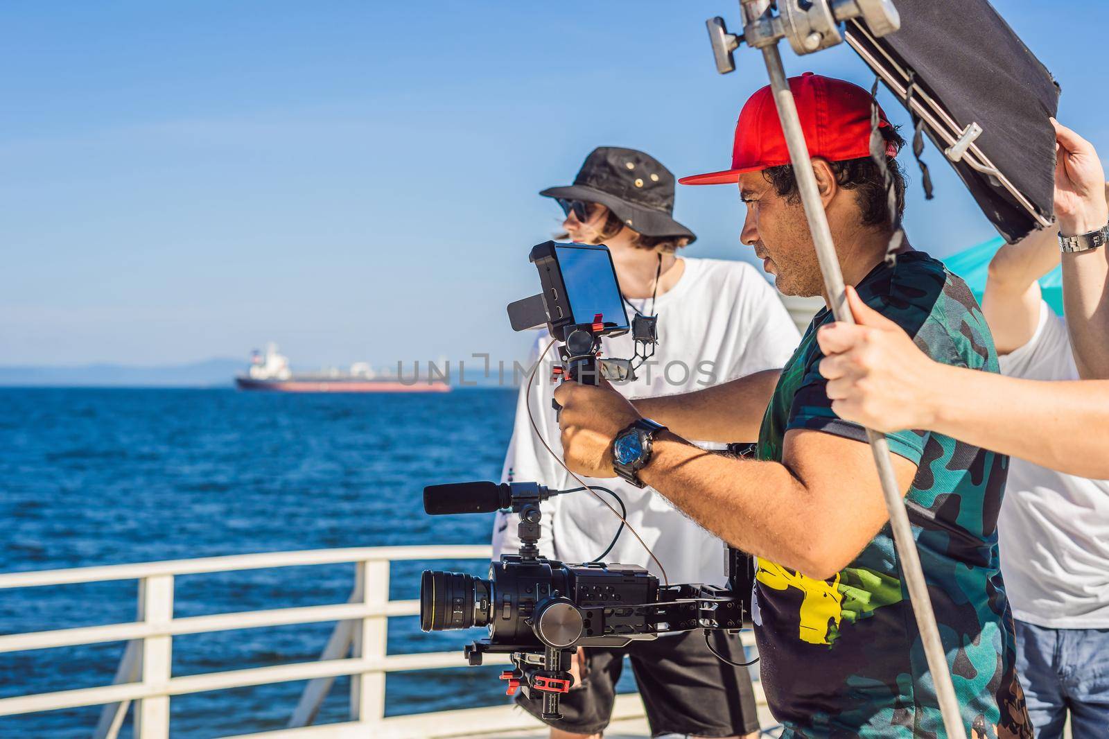 Professional steadicam operator uses a 3-axis camera stabilizer system on a commercial production set.