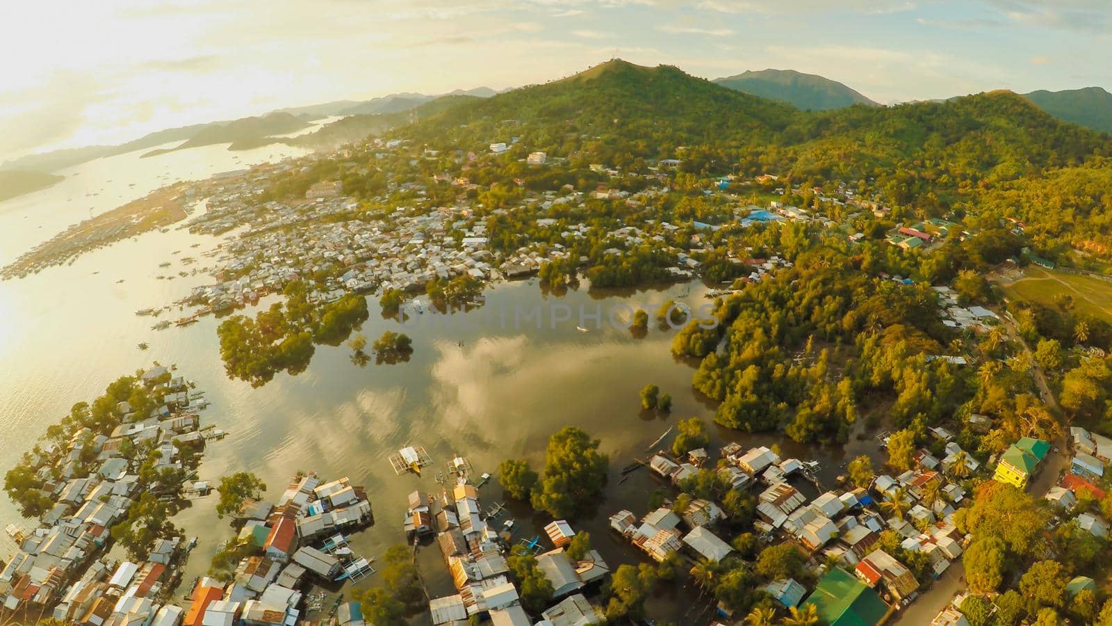 Aerial view Coron city with slums and poor district. Palawan. Busuanga island. Evening time and sunset. Fisheye view