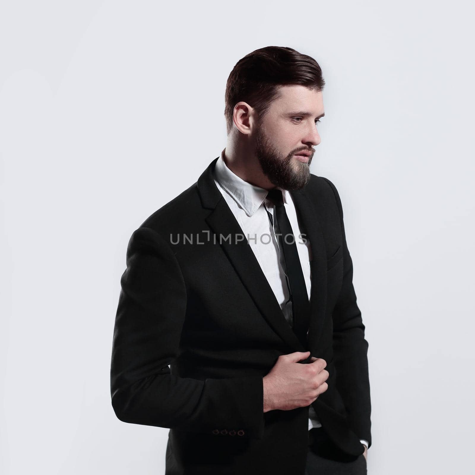 side view.portrait of a serious businessman.isolated on grey background.