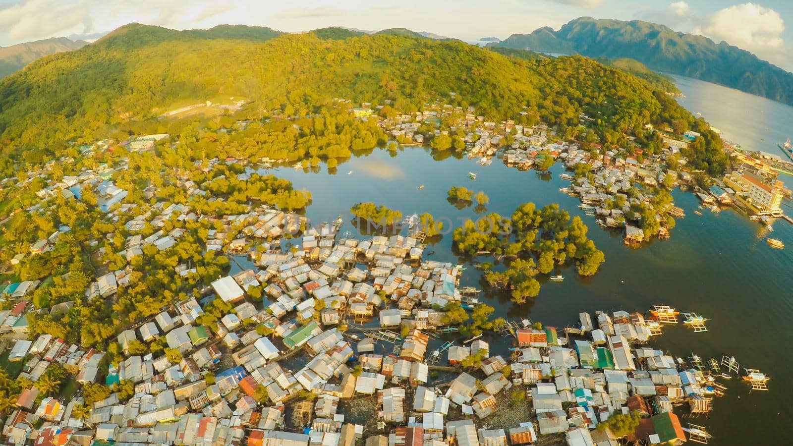 Aerial view Coron city with slums and poor district. Palawan. Busuanga island. Evening time and sunset. Fisheye view