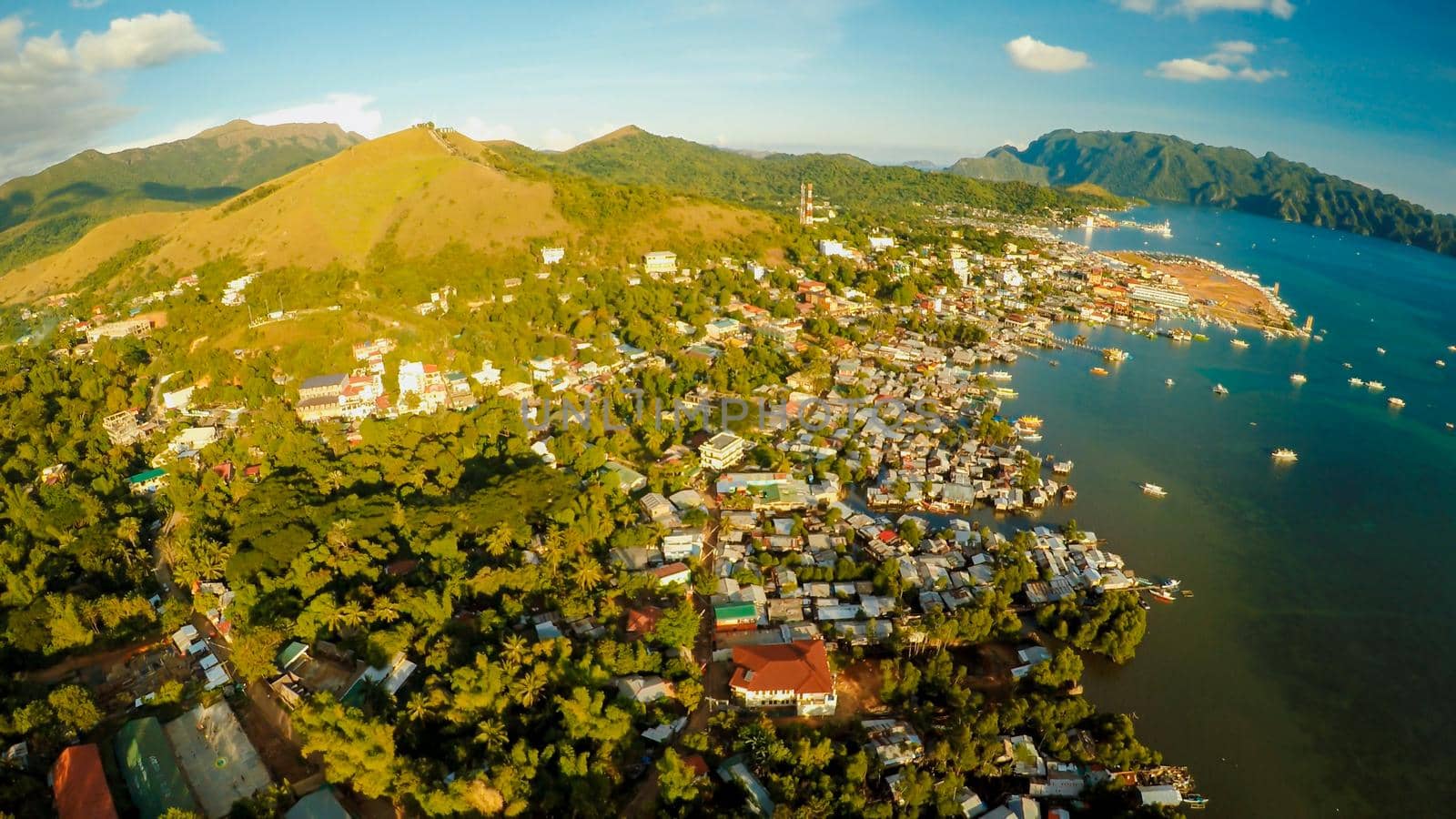 Aerial view Coron city with slums and poor district. Palawan. Busuanga island. Evening time and sunset. Fisheye view