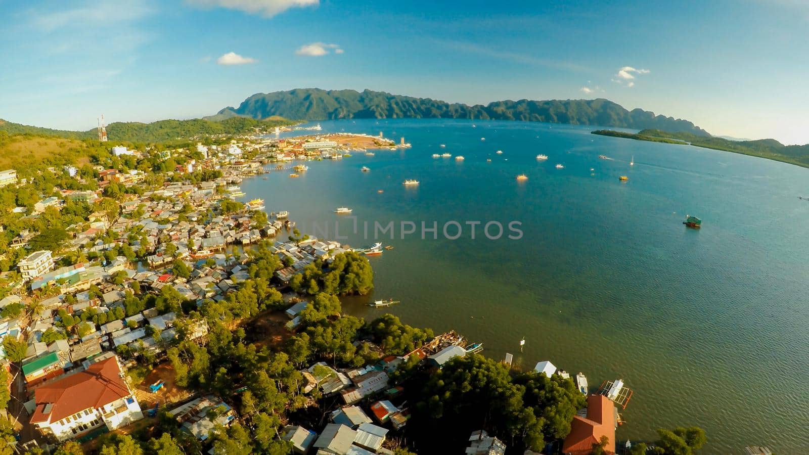 Aerial view Coron city with slums and poor district. Palawan. Busuanga island. Evening time and sunset. Fisheye view