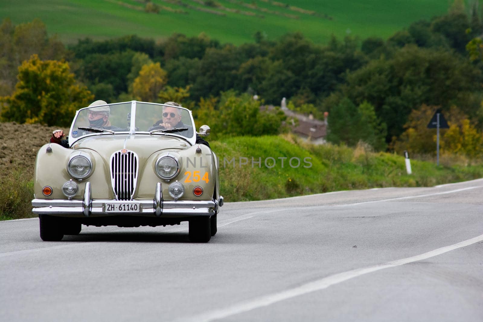 CAGLI , ITALY - OTT 24 - 2020 : JAGUAR XK 140 OTS SE 1954 on an old racing car in rally Mille Miglia 2020 the famous italian historical race (1927-1957