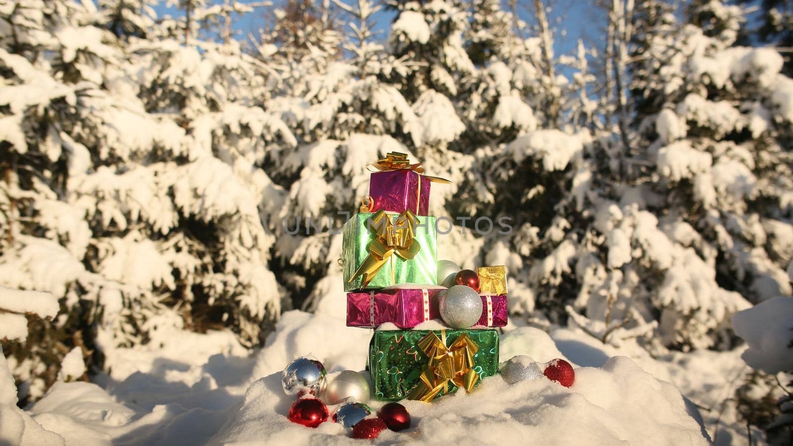 Christmas gifts in the snow-covered forest. New Year theme