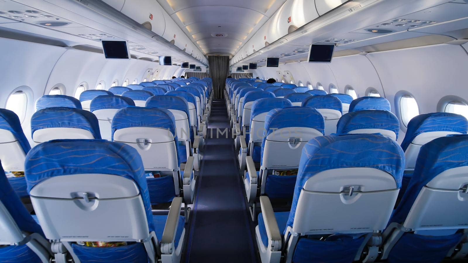 Empty aircraft cabin during flight. Blue salon