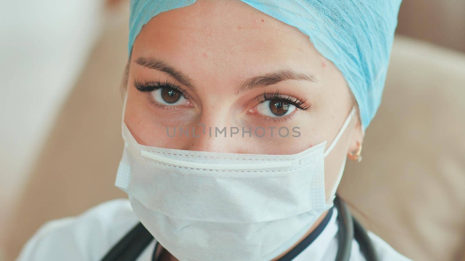 Close-up of young female doctor with a mask on face.