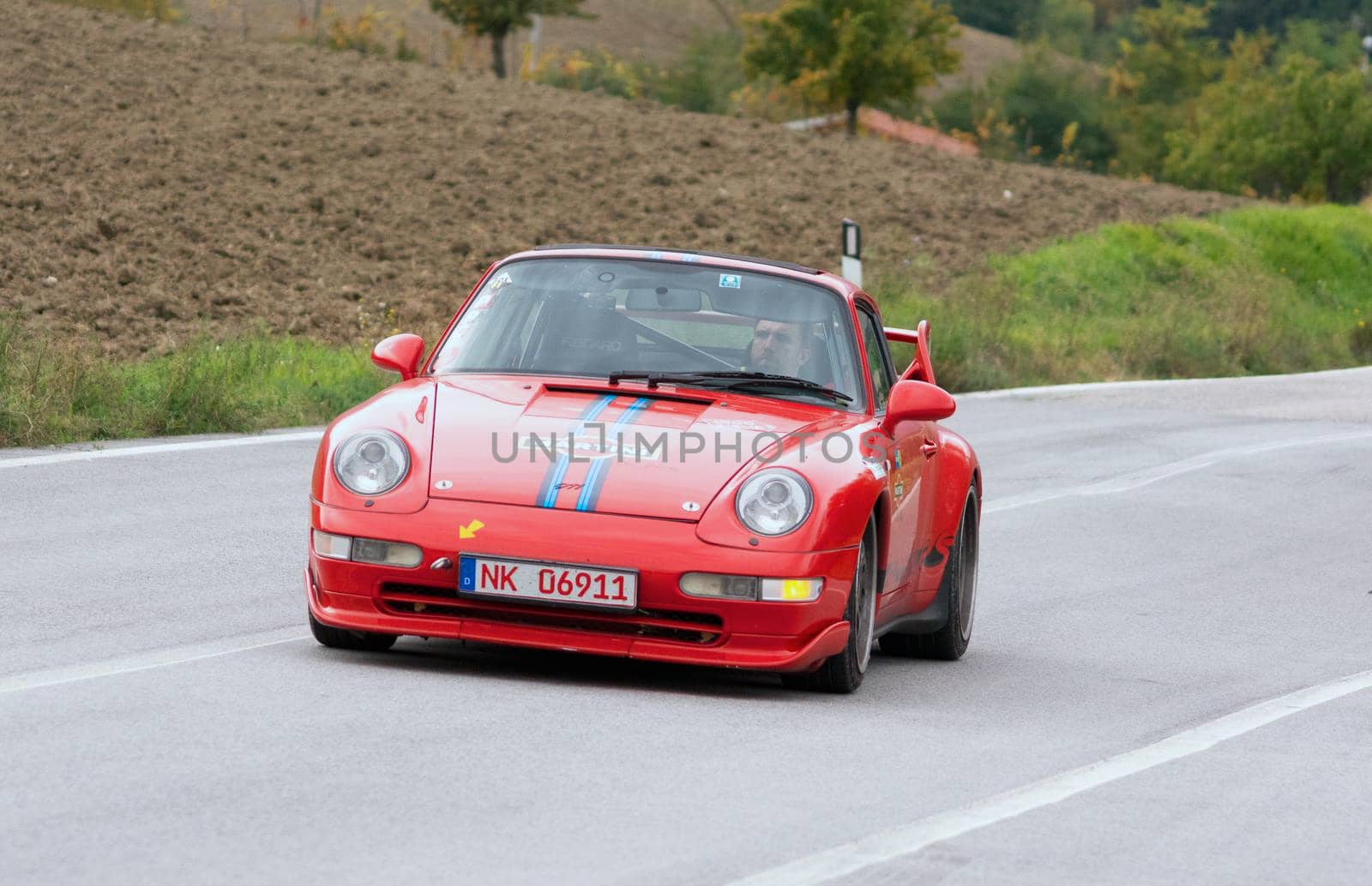 CAGLI , ITALY - OTT 24 - 2020 : PRSCHE CARRERA LIVREA MARTINI on an old racing car in rally Mille Miglia 2020 the famous italian historical race (1927-1957)