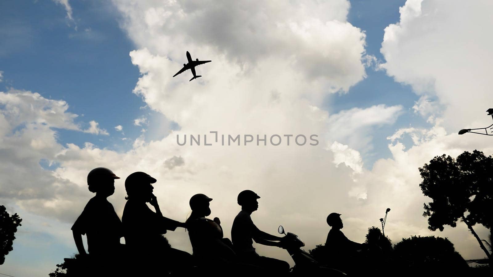 Passenger airplane taking off at sunset against the background of a very beautiful clouds and roads with traffic