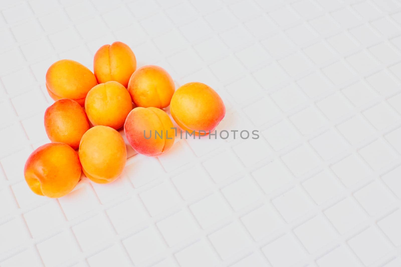 Fresh ripe apricot fruits isolated on white ribbed background by jovani68