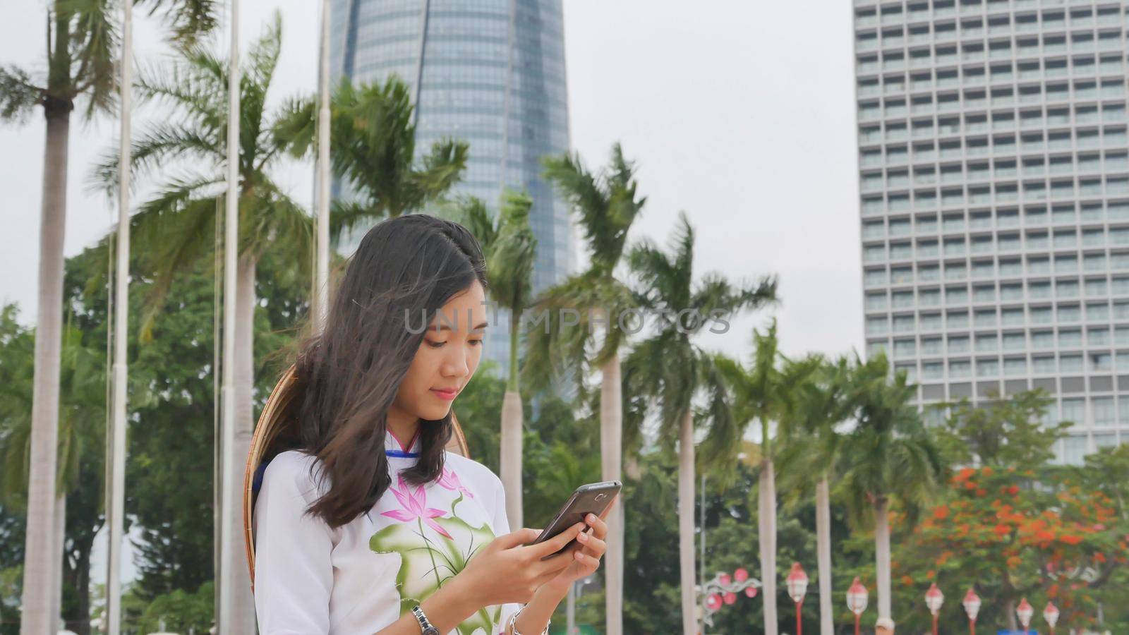 Vietnamese girl talking on the phone. Danang city.