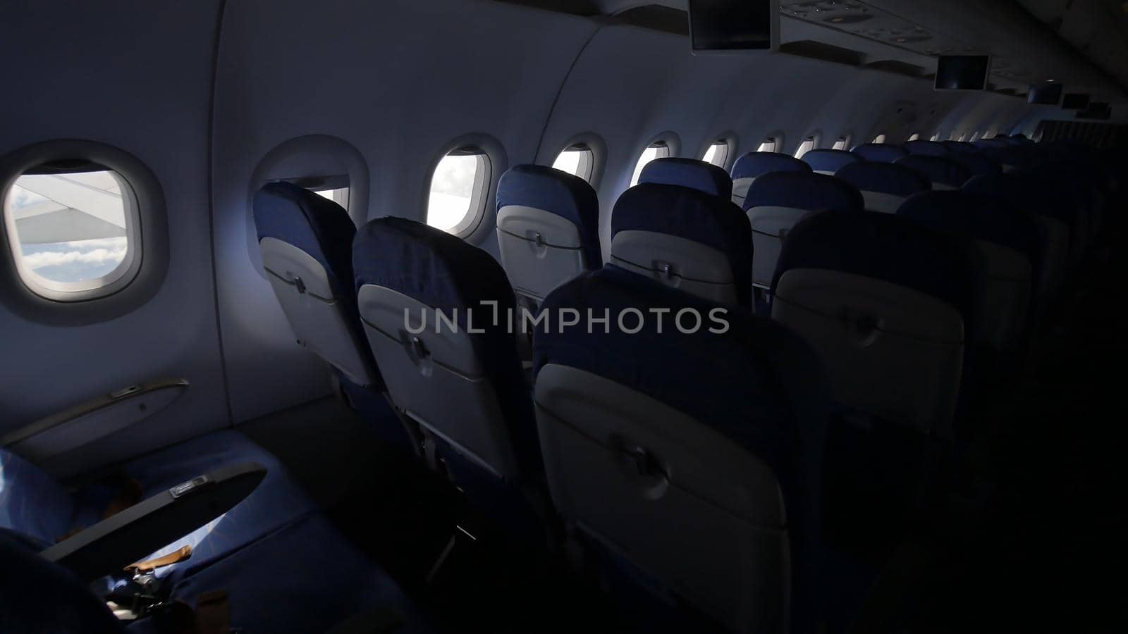 Looking out the window of an airplane as clouds pass by. by DovidPro