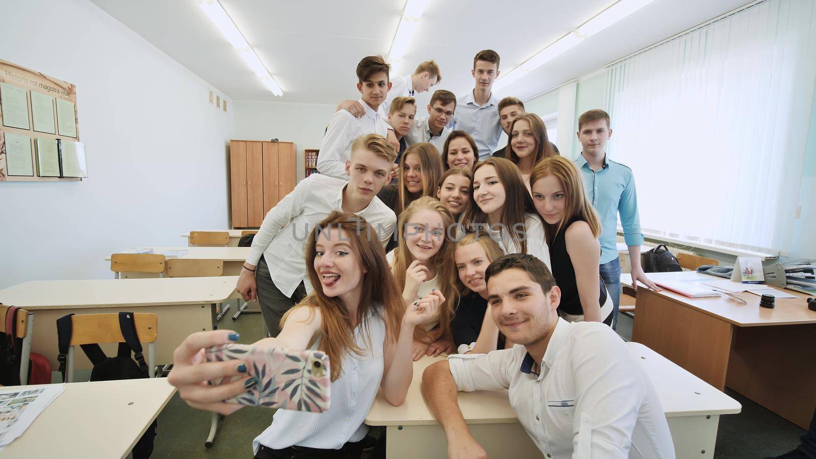 Young happy cheerful students making selfie in campus