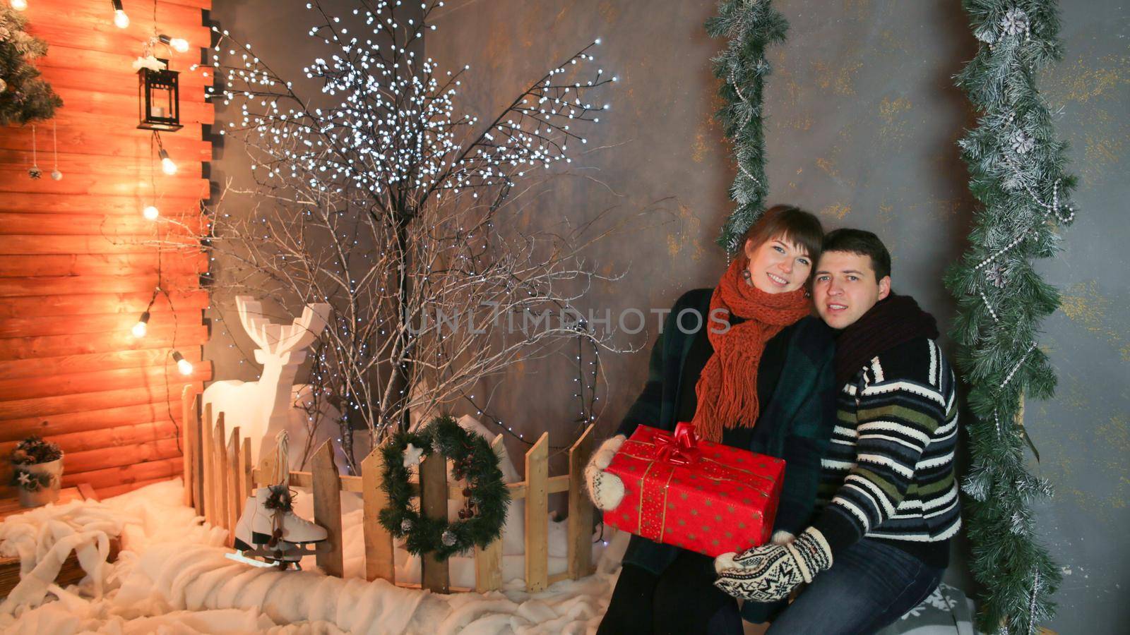 A loving couple enjoy each other against a background of fairytale decorations. Christmas and New Year theme