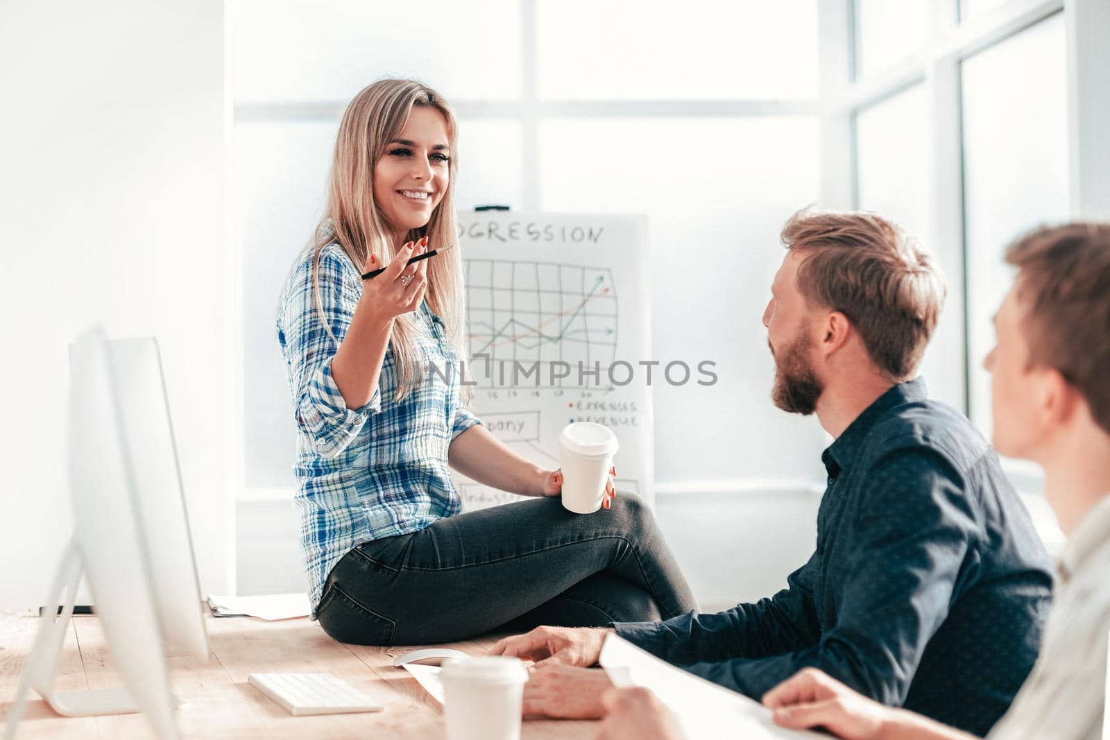 young woman discussing with colleagues new strategy by SmartPhotoLab