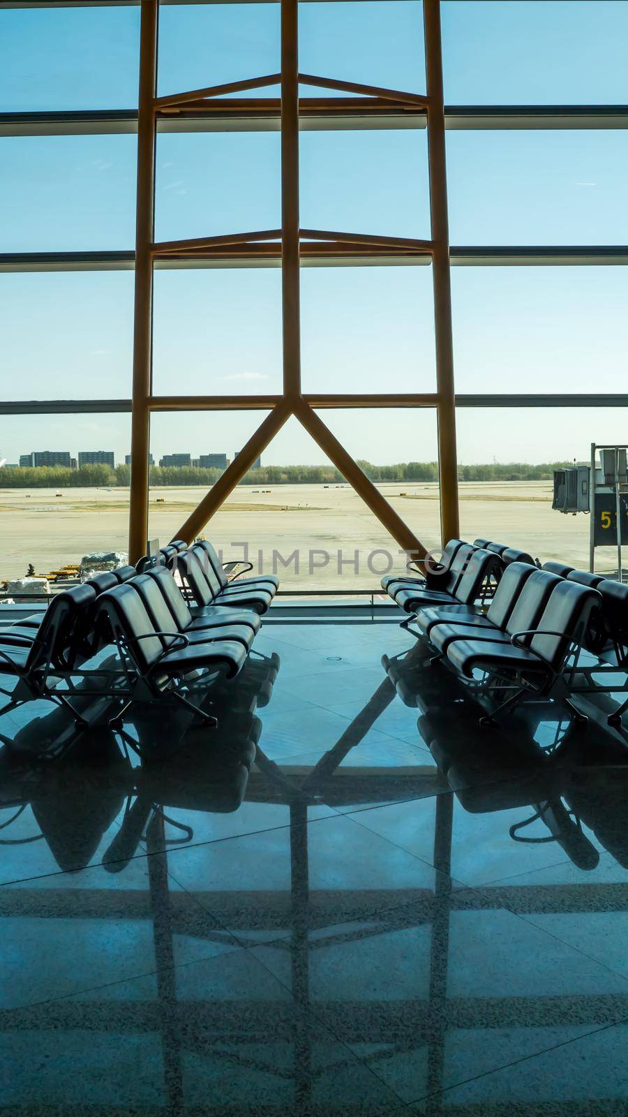 Empty empty airport terminal with passenger seats by DovidPro