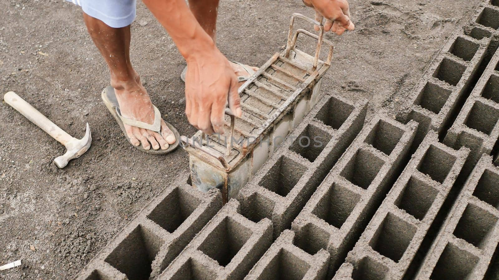 Man manually produces brick molds for construction from volcanic ash in the city of Legazpi. Philippines