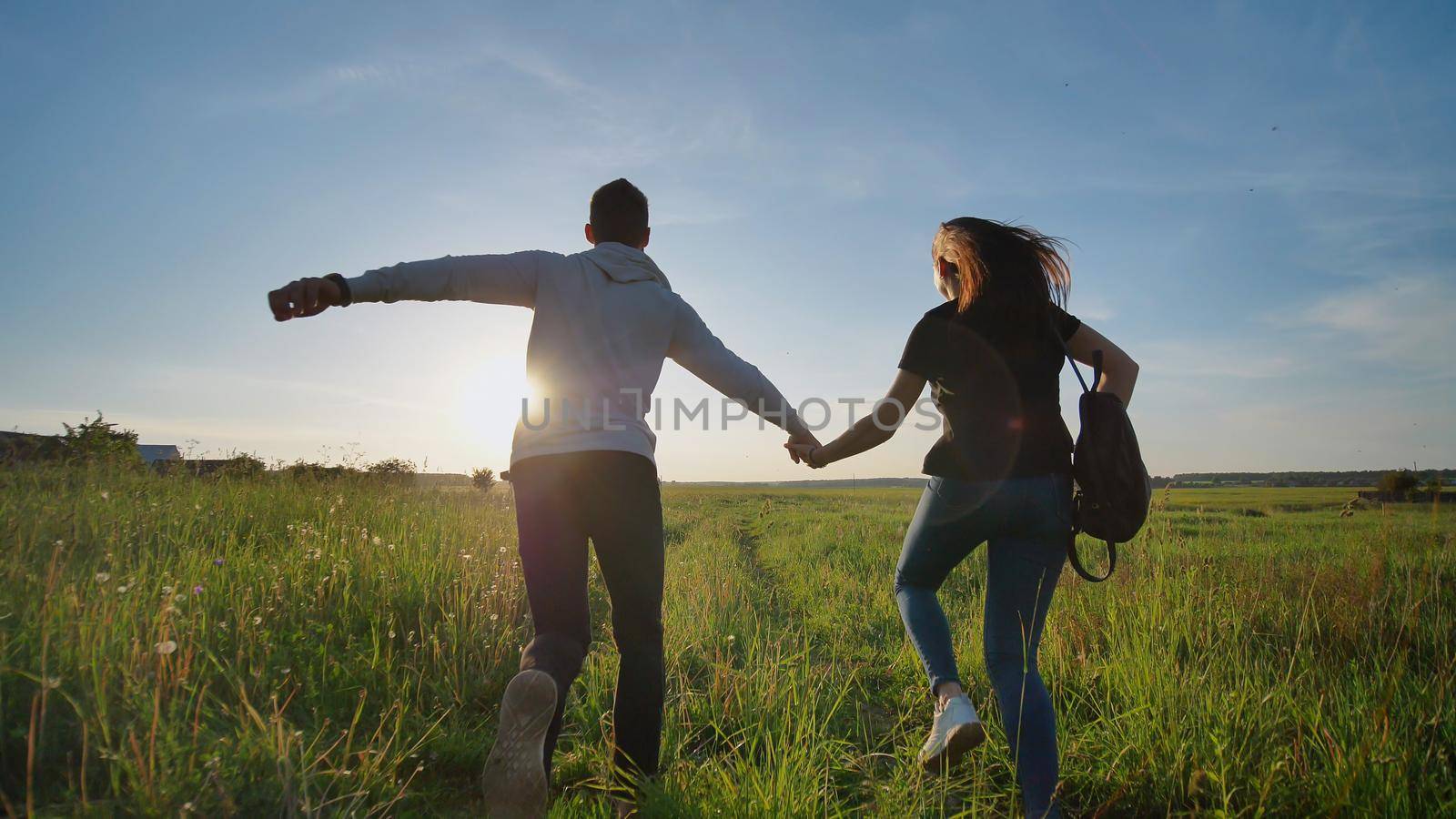 Happy senior pupils flee and toss their portfolios against the sunset. Happy ending school days. Slow motion. by DovidPro