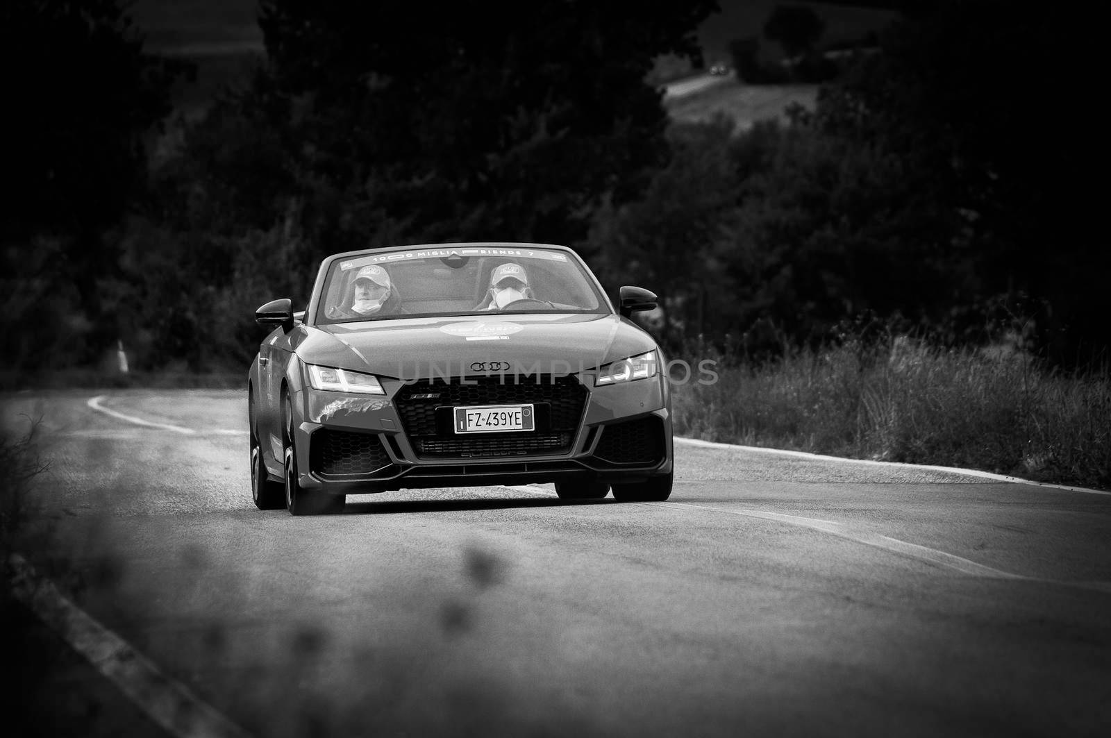 CAGLI , ITALY - OTT 24 - 2020 : audi tt roadster rs on an old racing car in rally Mille Miglia 2020 the famous italian historical race (1927-1957)