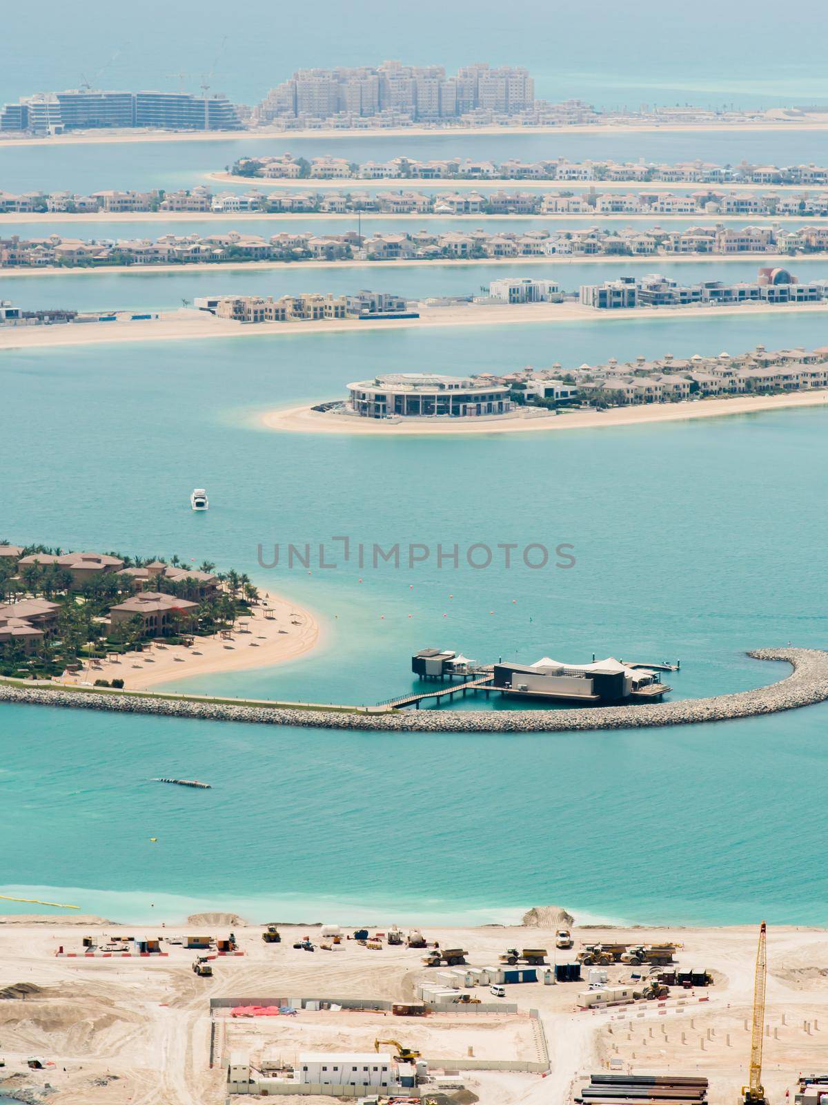 View on residential buildings on Palm Jumeirah island. The Palm Jumeirah is an artificial archipelago in Dubai emirate. by DovidPro