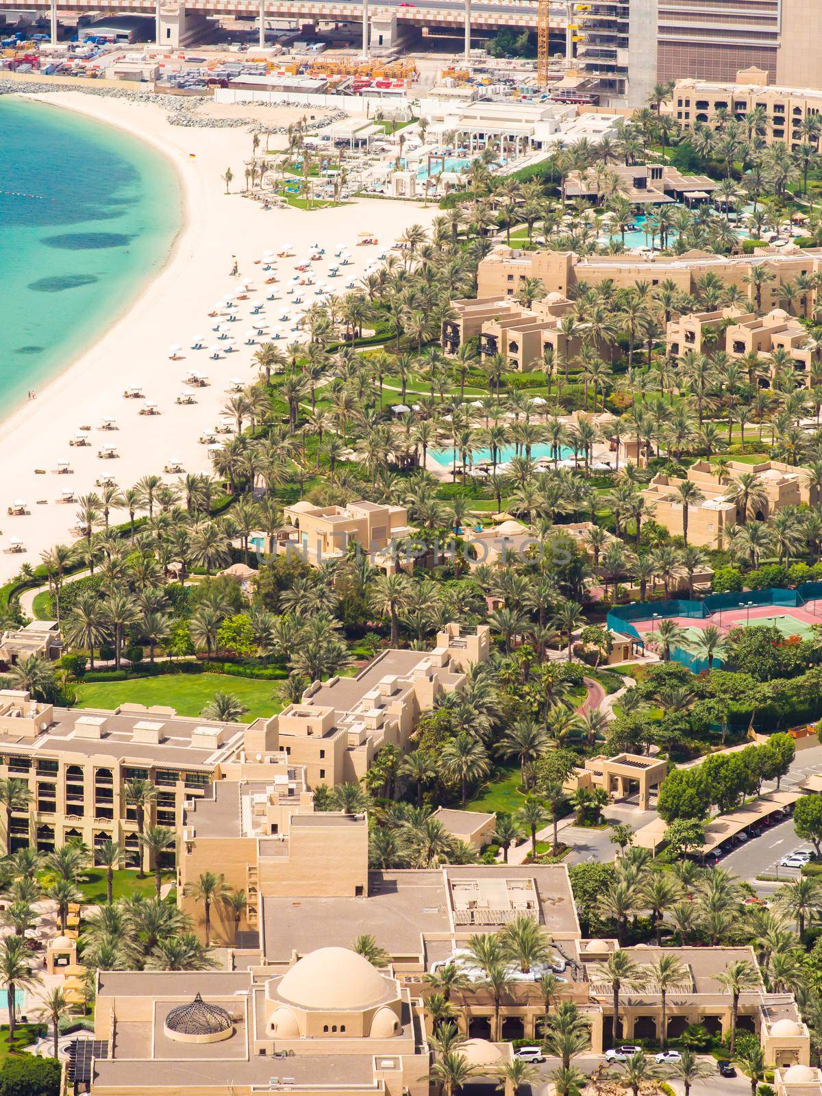 Beach coast with open pool hotels in Dubai. View from the height