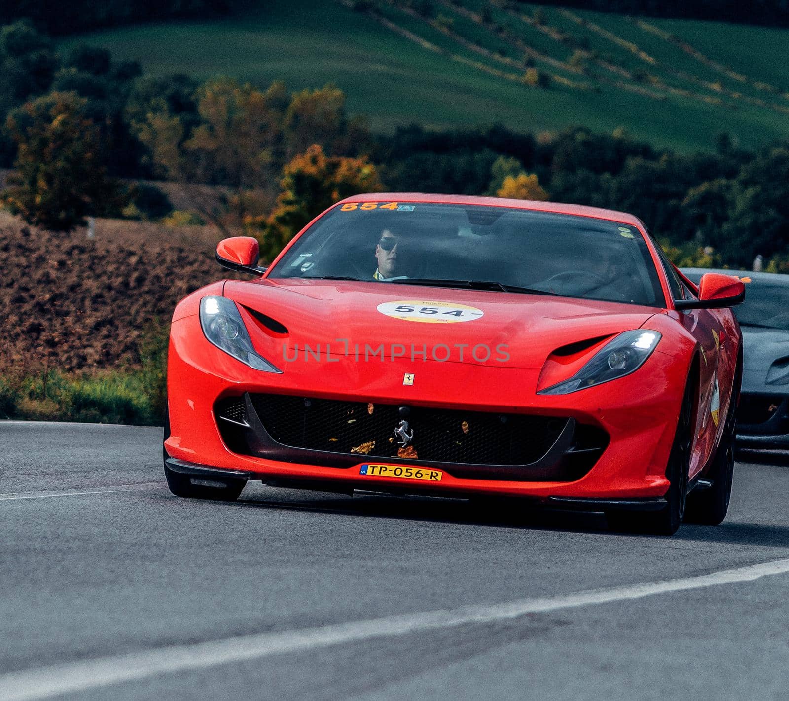 CAGLI , ITALY - OTT 24 - 2020 : Ferrari 812 SUPERFAST 2018 on an old racing car in rally Mille Miglia 2020 the famous italian historical race (1927-1957)