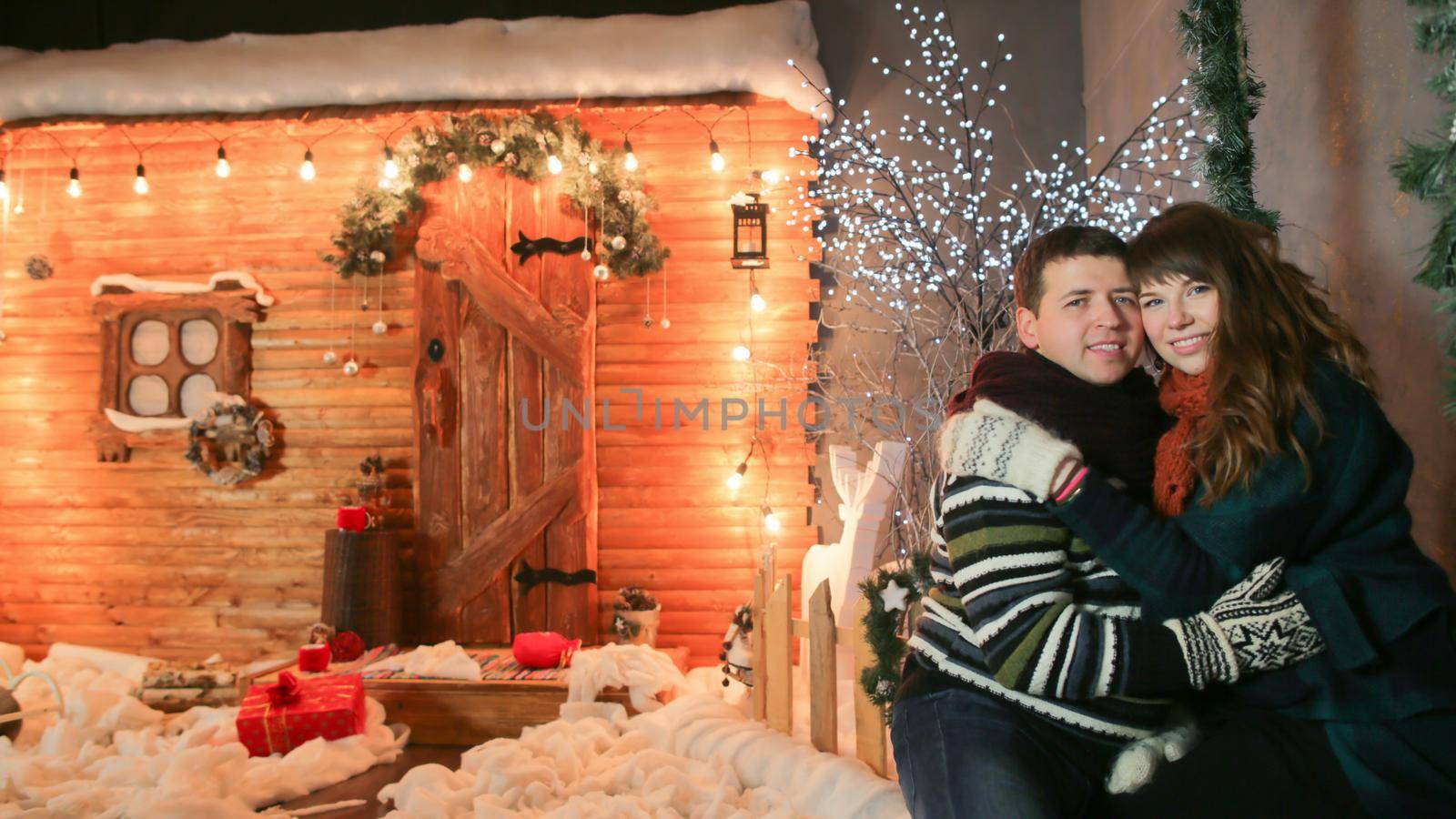 A loving couple enjoy each other against a background of fairytale decorations. Christmas and New Year theme