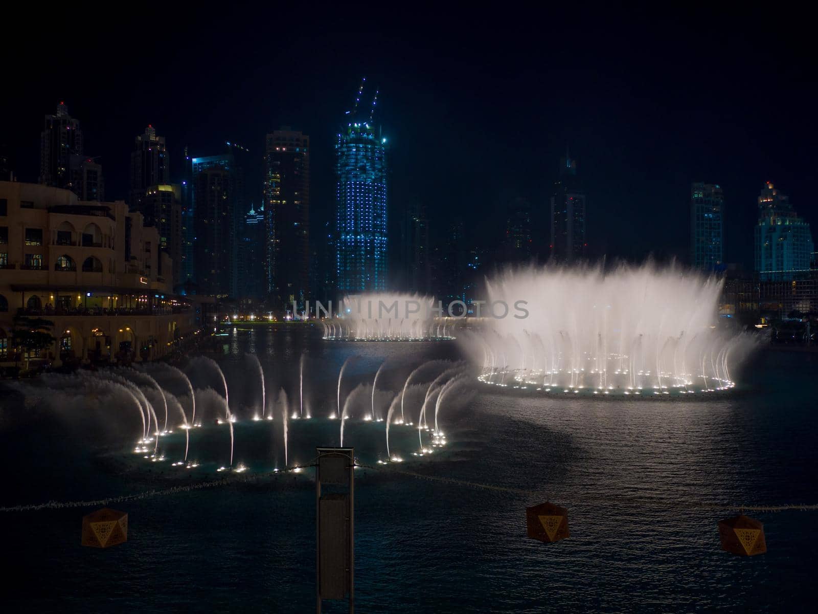 Dancing fountain with lighting in the city at night. by DovidPro