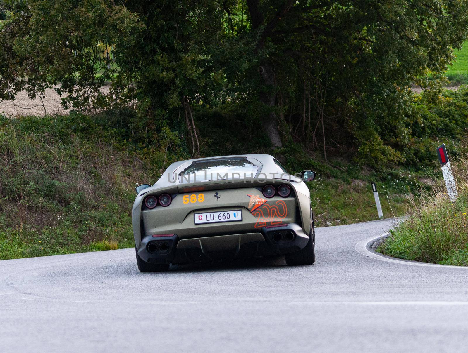 ITALY - OTT 24 - 2020 : FERRARI 812 SUPERFAST on an old racing car in rally Mille Miglia 2020 the famous italian historical race (1927-1957)