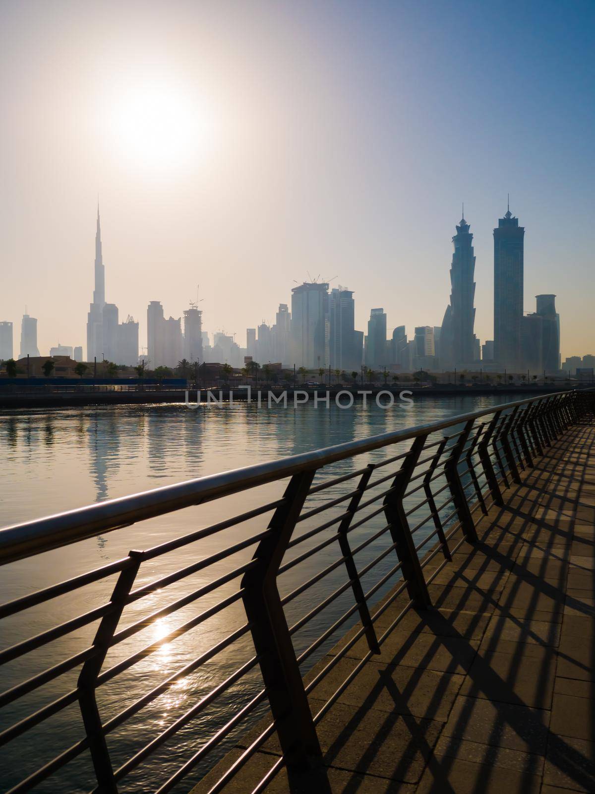 Panorama of the city of Dubai early in the morning at sunrise with a bridge over the city channel Dubai Greek. by DovidPro