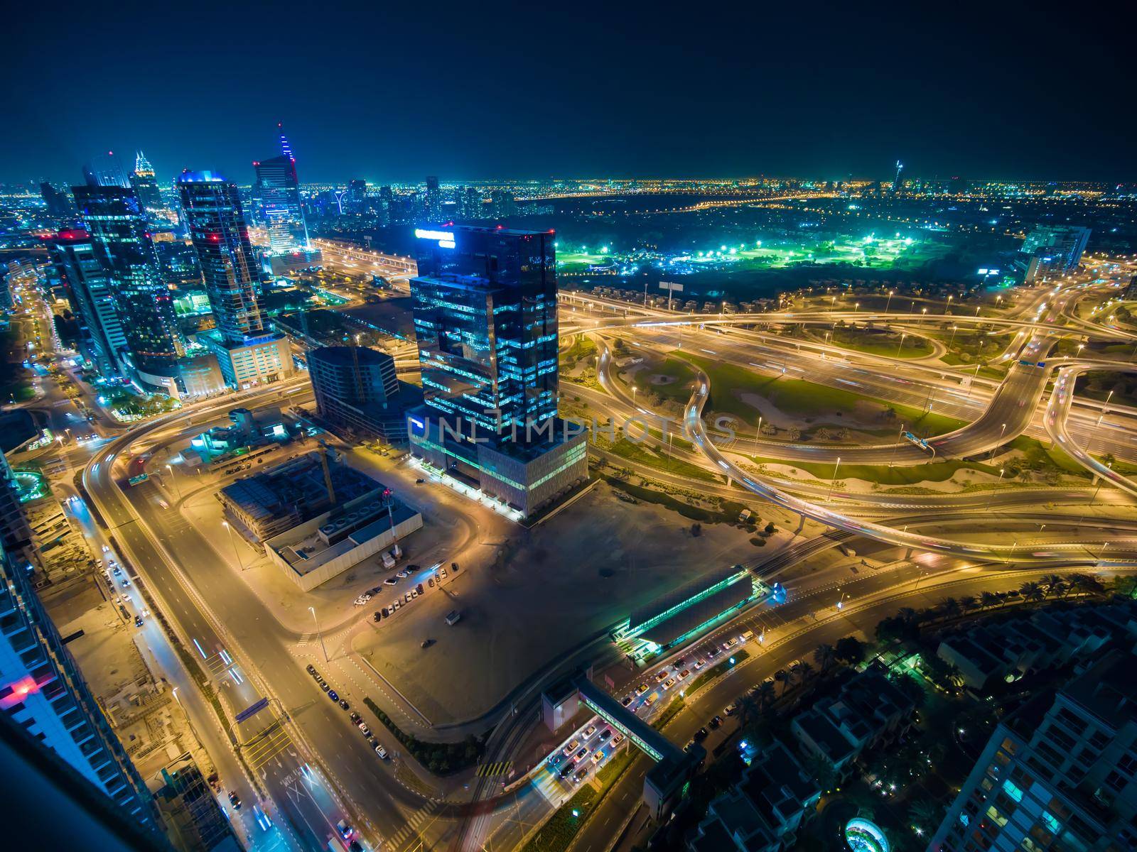 Panorama of the Dubai area with a road junction and traffic at night