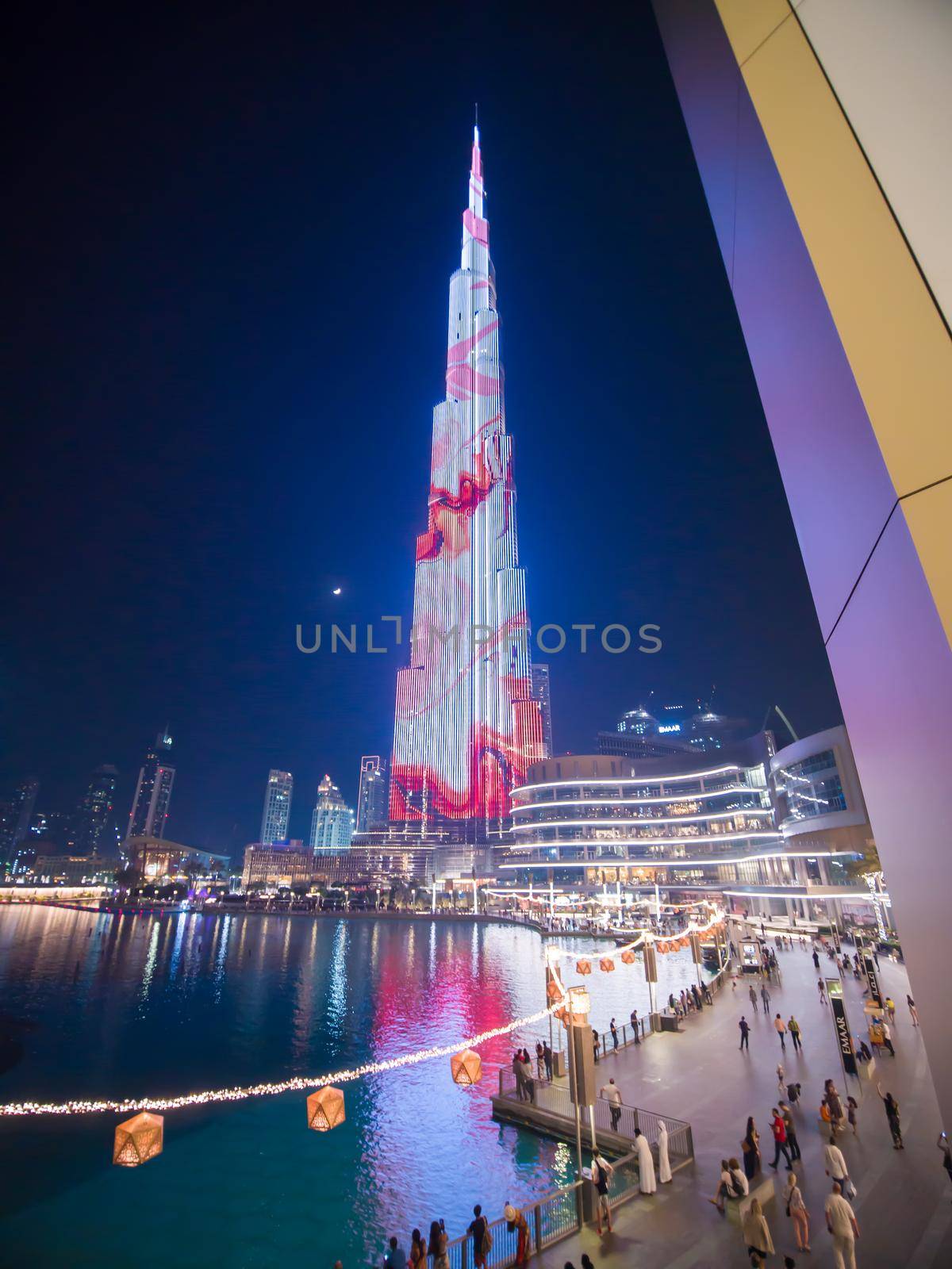 Dubai, UAE - May 15, 2018: Square of Dubai fountains with illuminations of the Khalifa Tower. by DovidPro