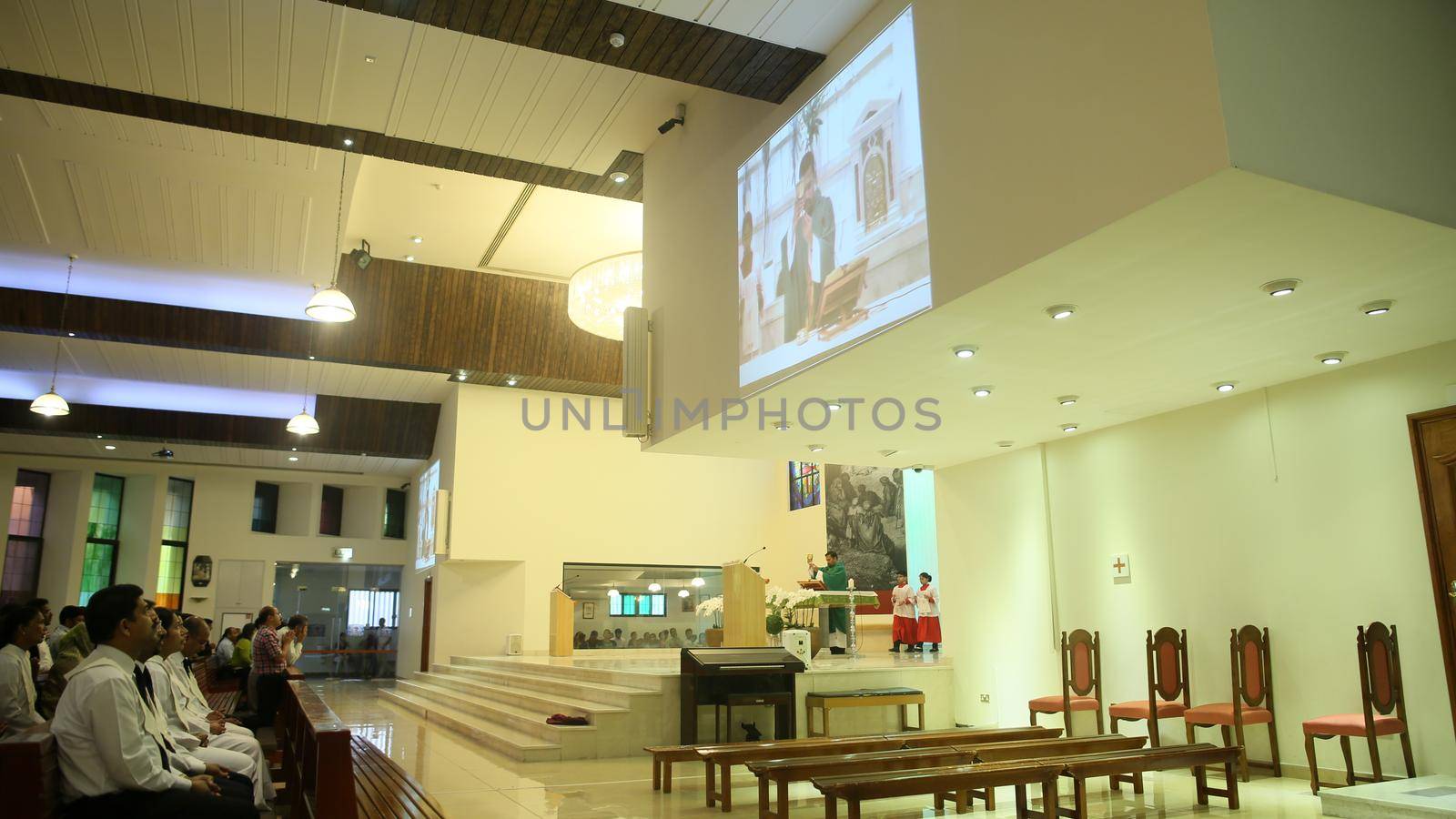 DUBAI, UAE - AUGUST 20, 2014: Catholic church during the service with people.. Christianity in Muslim countries. by DovidPro