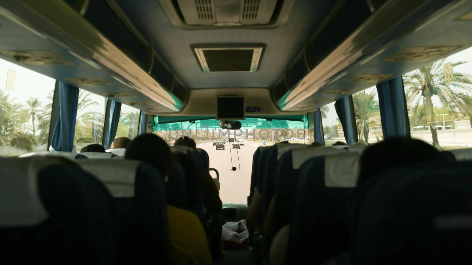 Inside the tourist bus with passengers. Travel to Abu Dhabi. by DovidPro