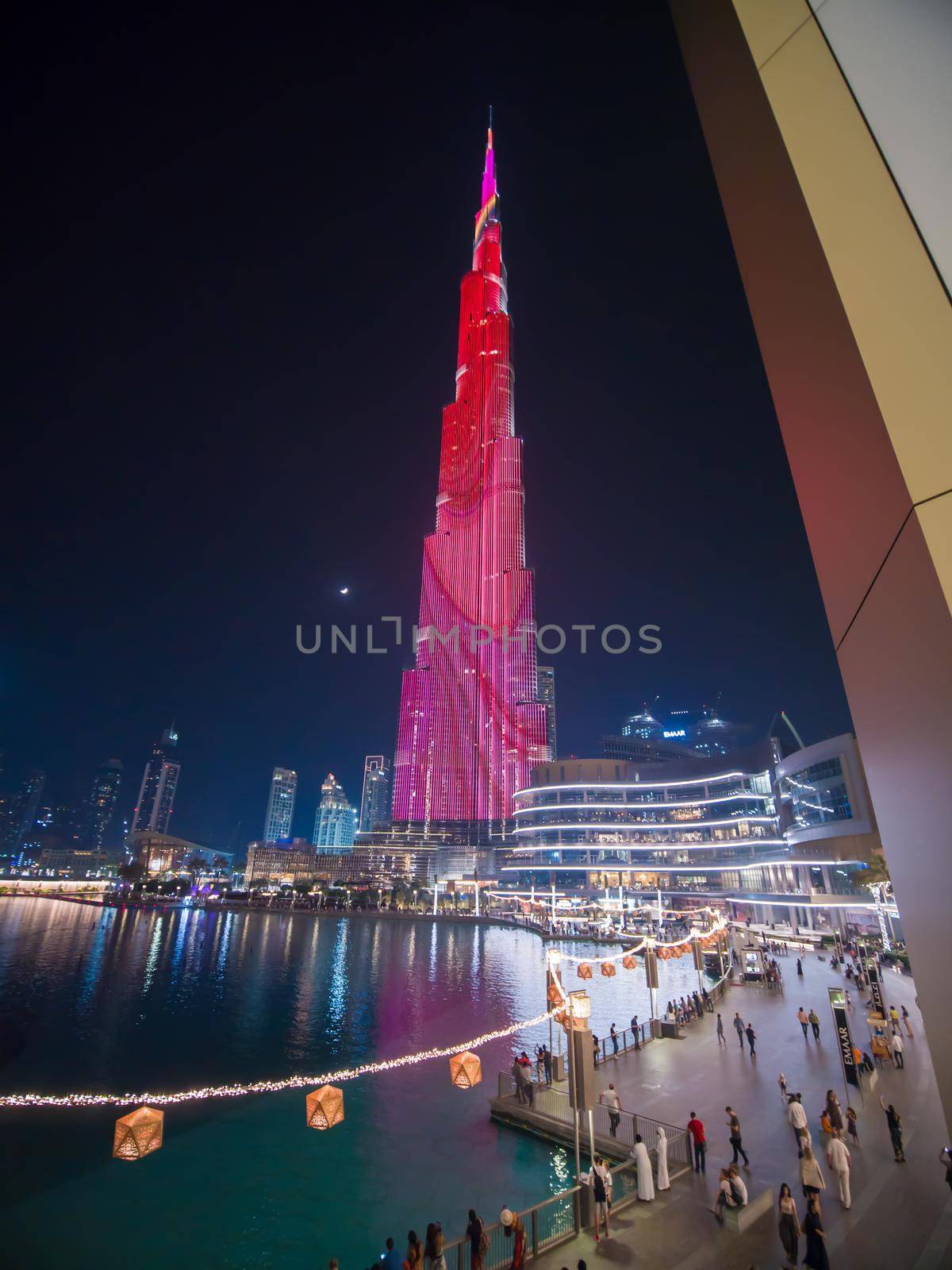 Dubai, UAE - May 15, 2018: Square of Dubai fountains with illuminations of the Khalifa Tower. by DovidPro