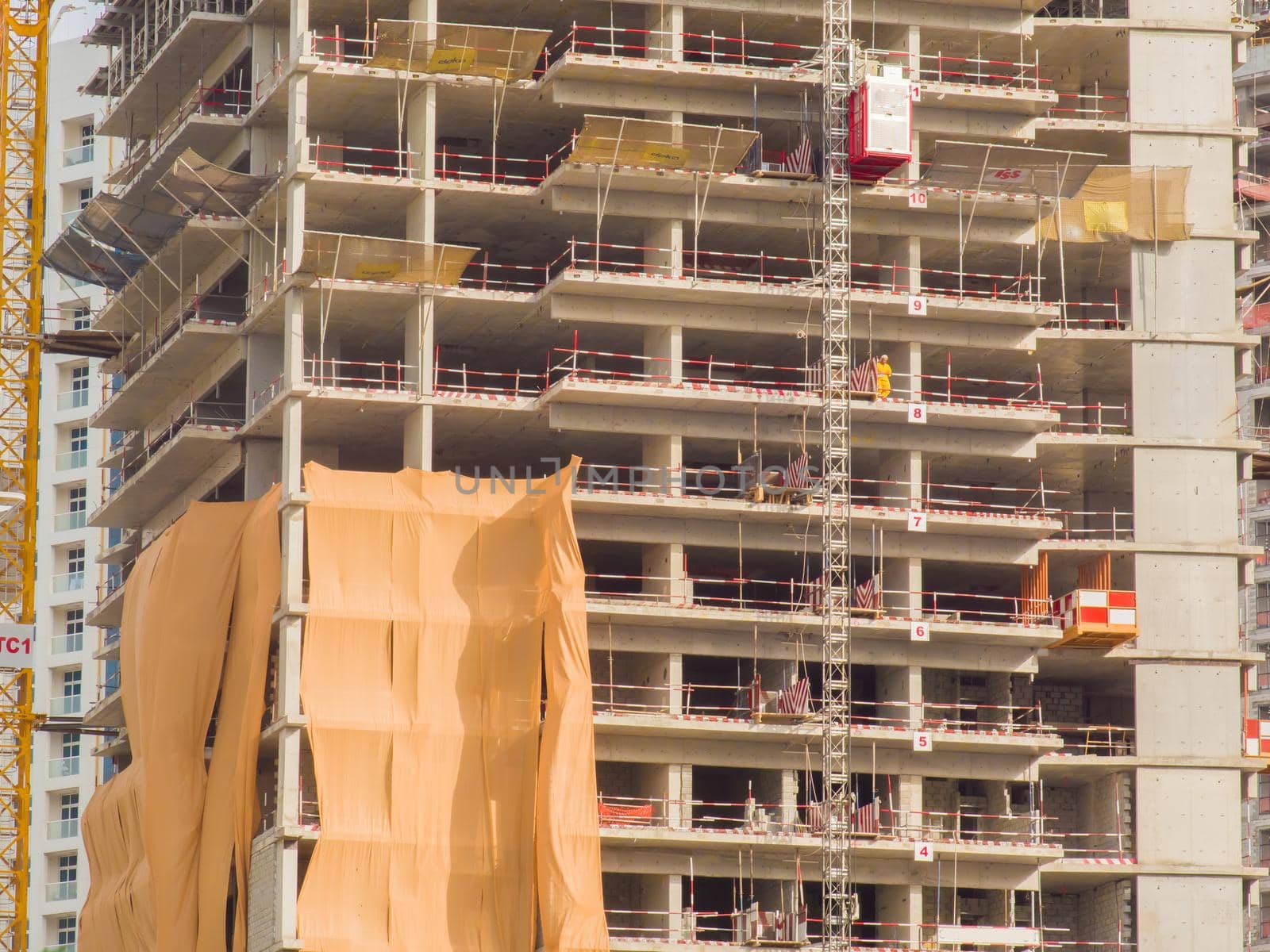 Construction of a multi-storey building in Dubai. Unfinished building facade close-up