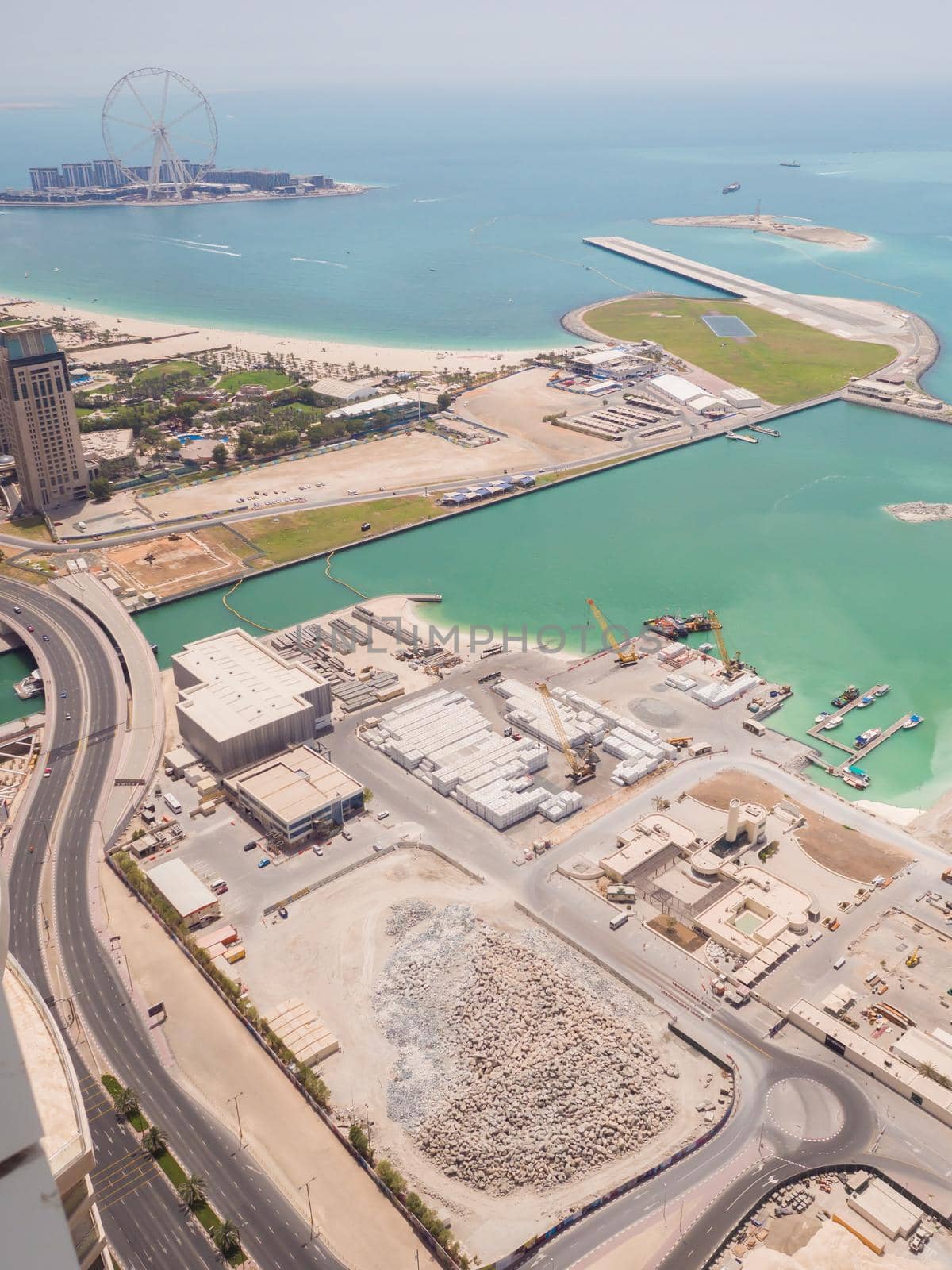 Construction of an artificial island Palm Jumeirah with construction equipment in Dubai. by DovidPro
