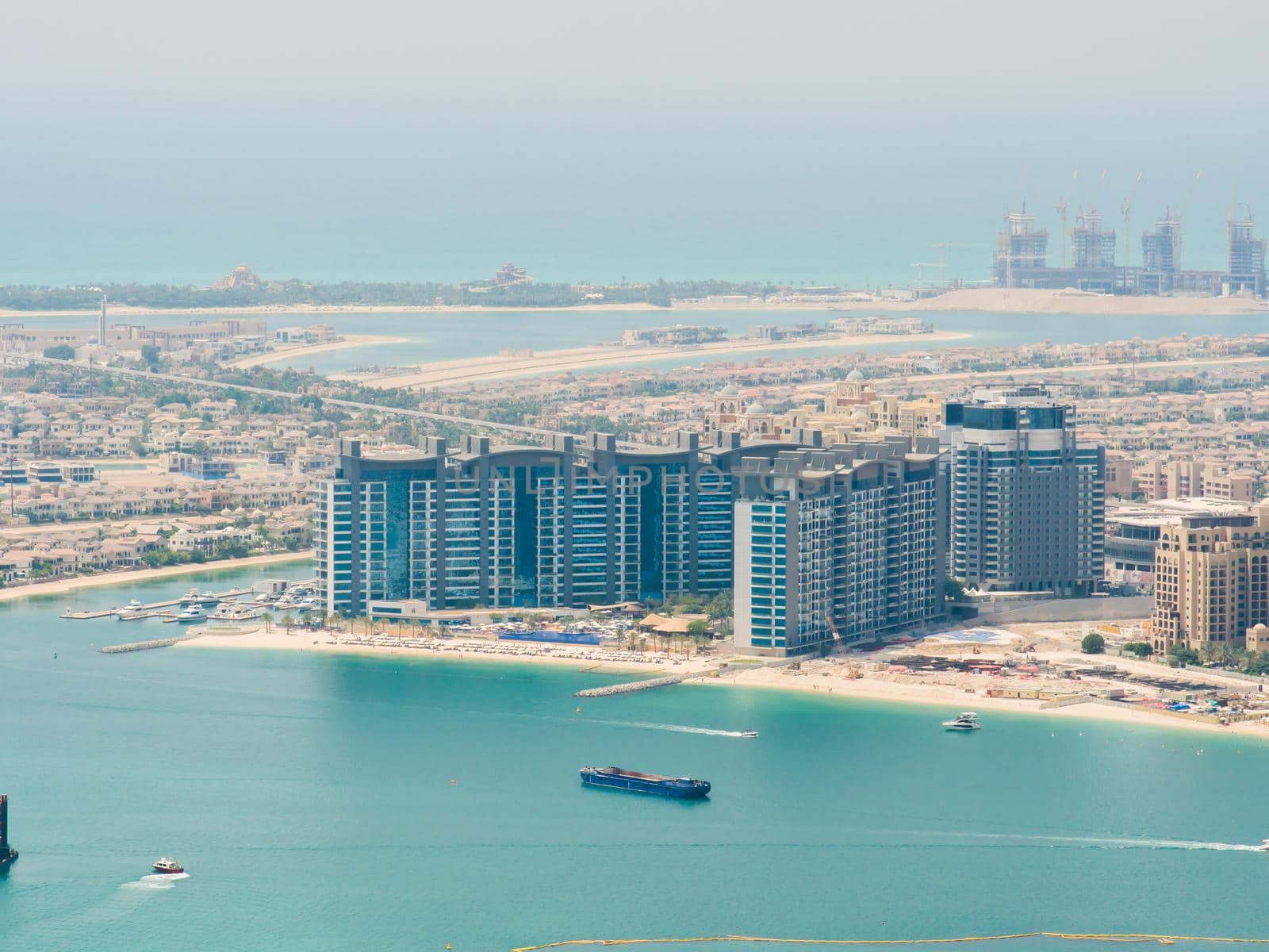 View on residential buildings on Palm Jumeirah island. The Palm Jumeirah is an artificial archipelago in Dubai emirate. by DovidPro