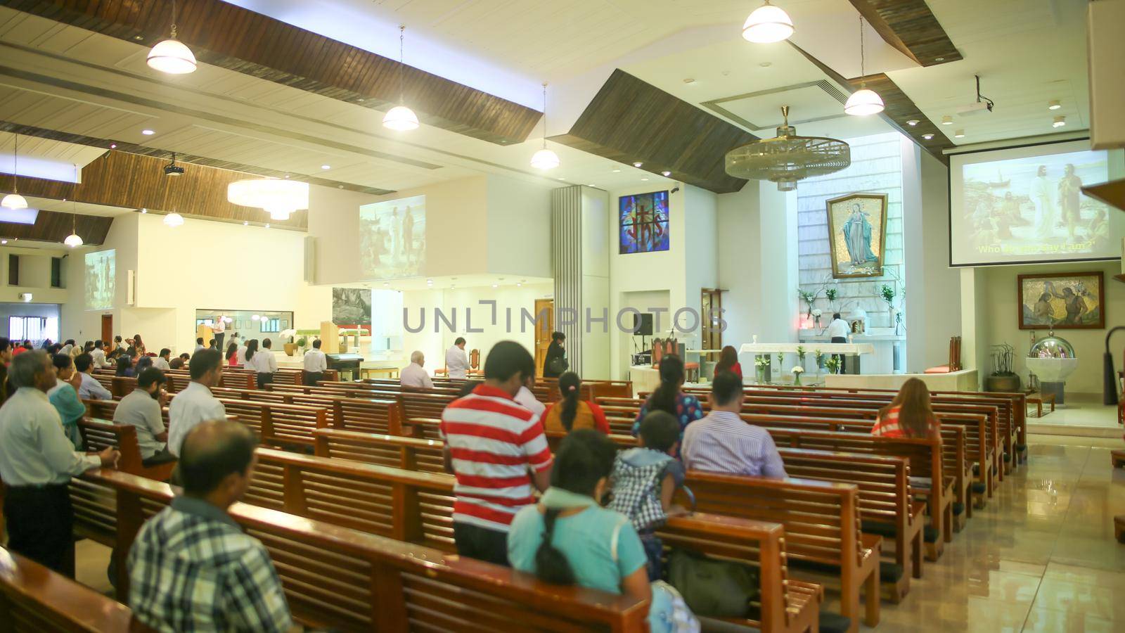 DUBAI, UAE - AUGUST 20, 2014: Catholic church during the service with people.. Christianity in Muslim countries. by DovidPro