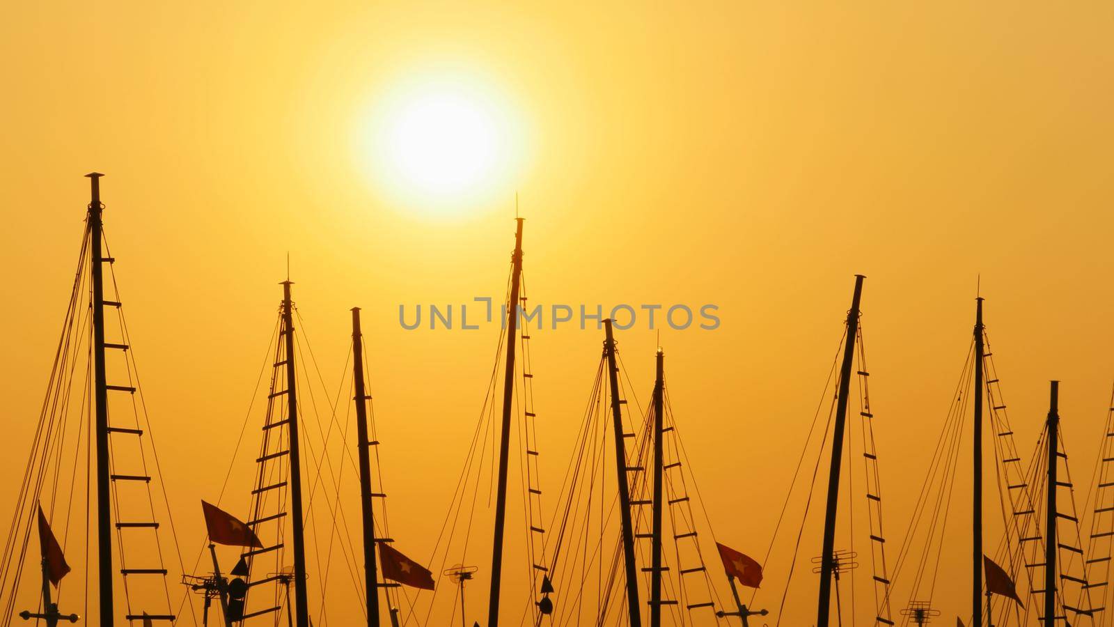 Masts of ships and boats at sunset. Vietnam