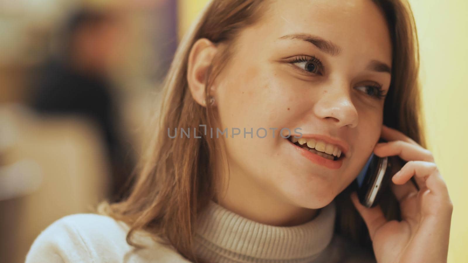 Cute young girl talking on a cell phone. Close-up