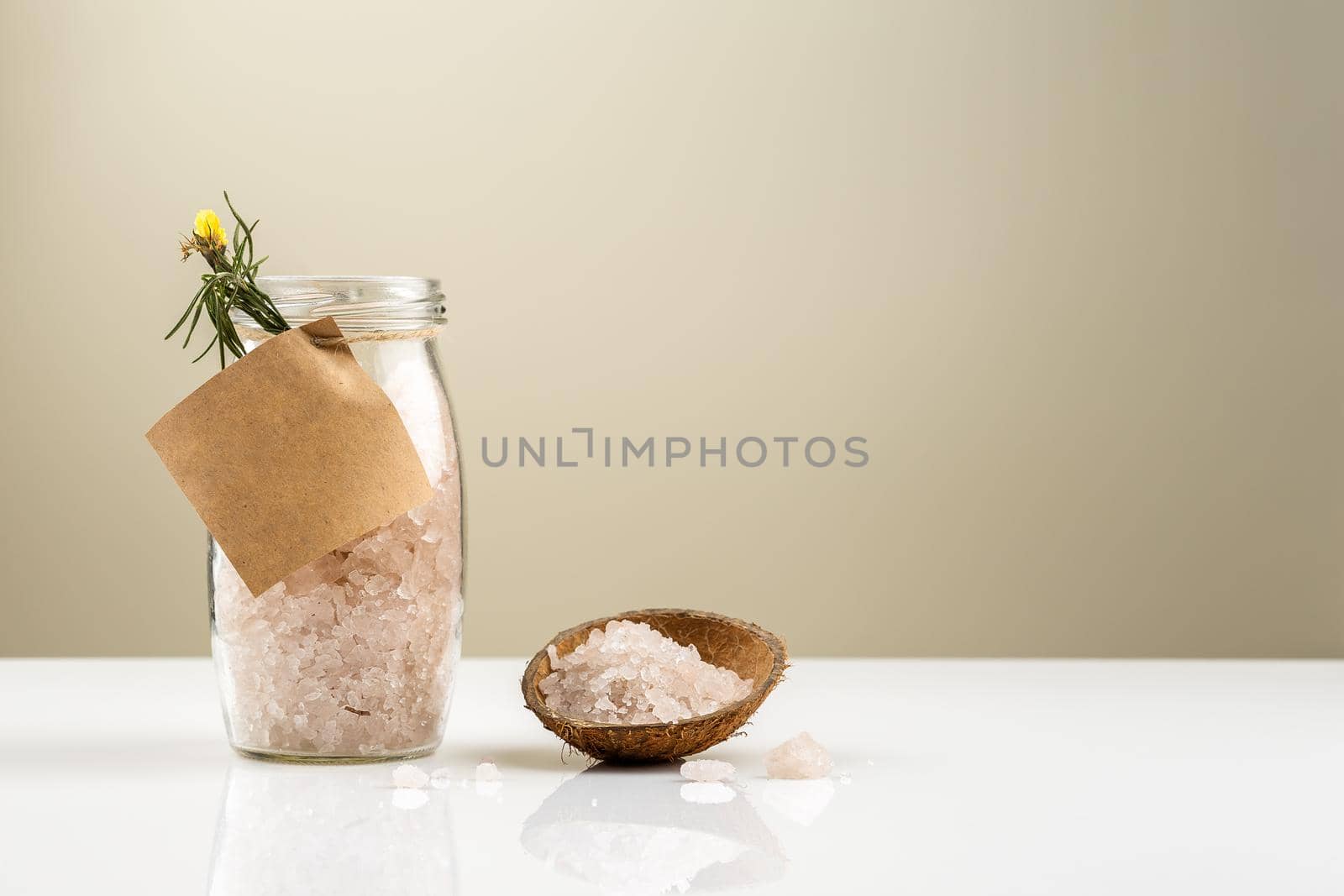 Glass jar with bath salt with empty label on it. Sea salts for relaxation and treatment. Copy Space for text