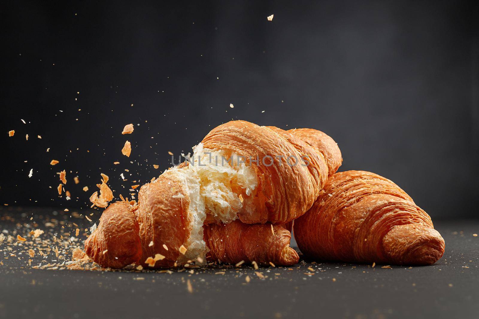 Breakfast concept. French pastry isolated on dark background
