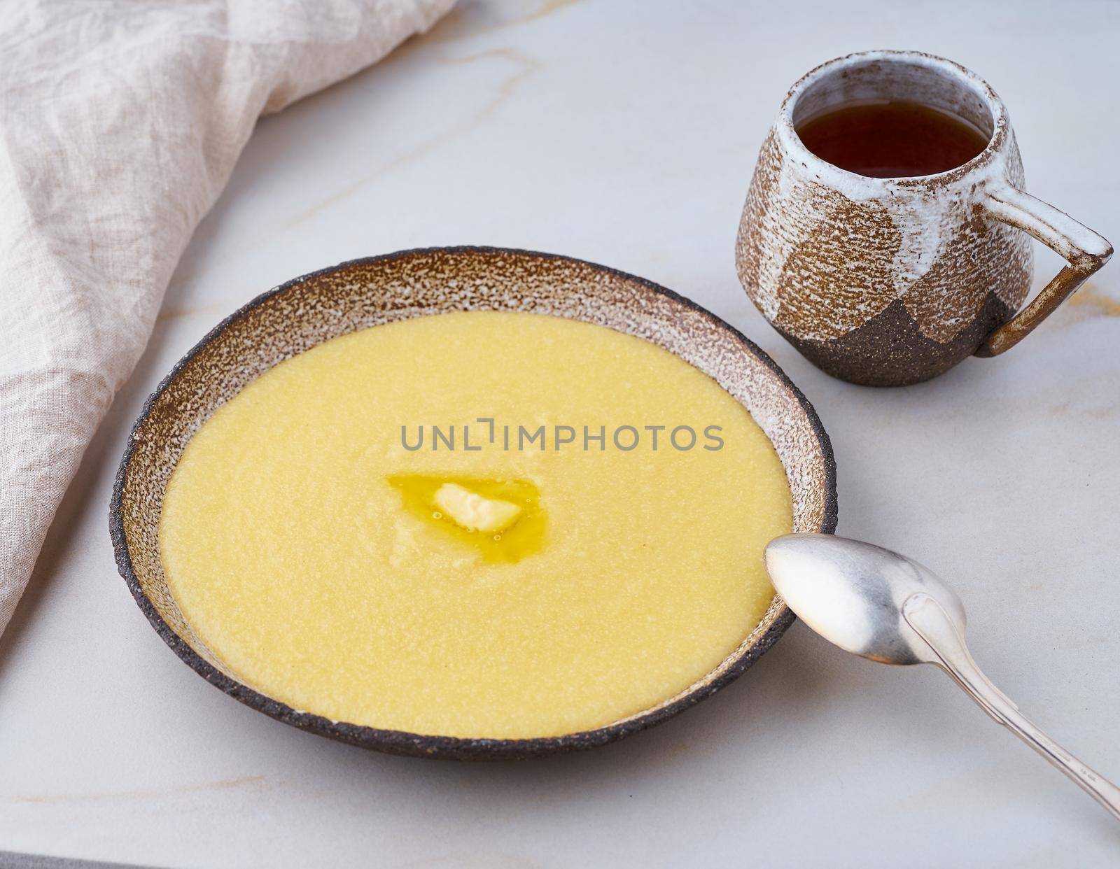 porridge polenta with butter and cup tea, white background pastel closeup by NataBene